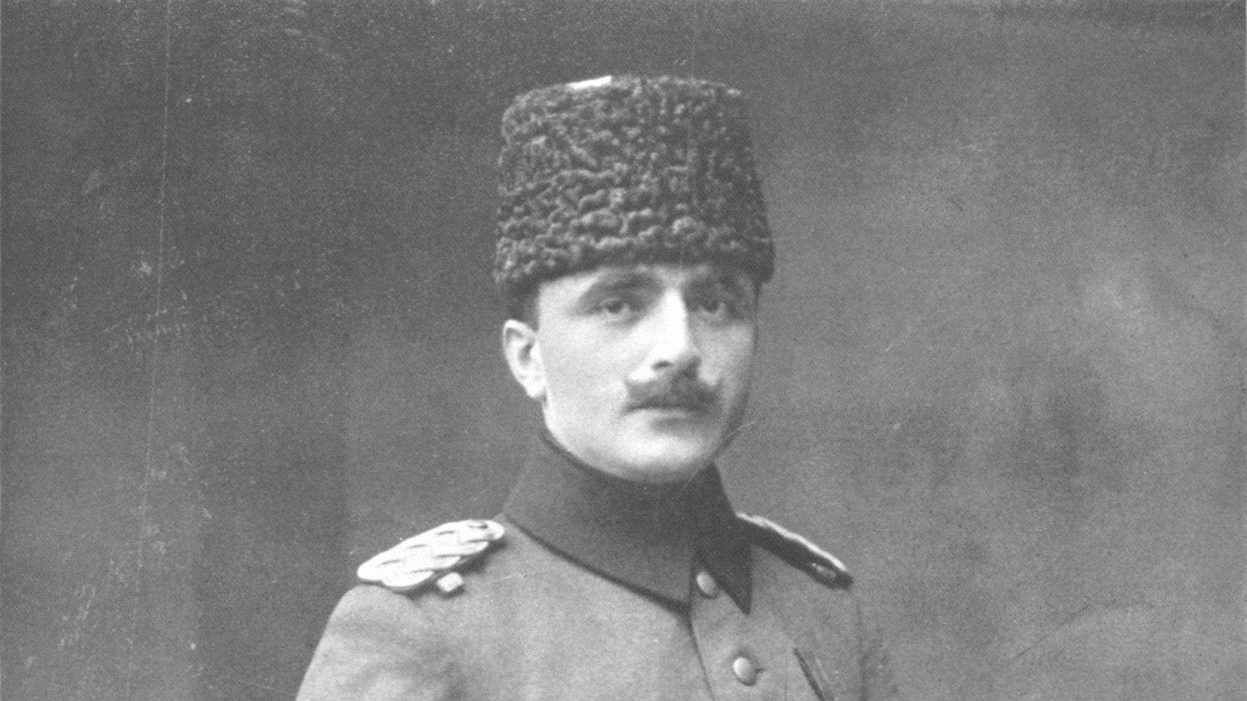 A formal 1917 studio portrait of Enver Pasha in Ottoman military uniform and karakul hat, published in the Austrian magazine Sport & Salon and captioned as the Turkish War Minister