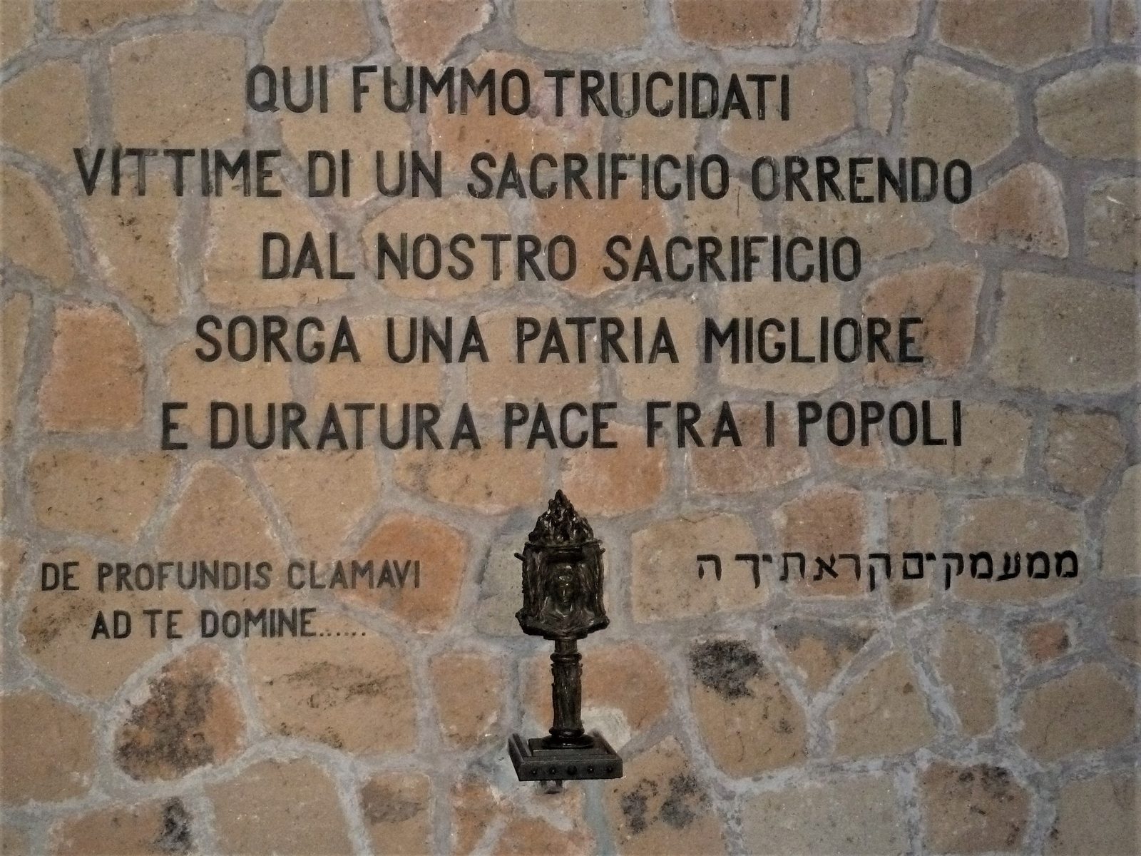 The inscription at the entrance of the Fosse Ardeatine mausoleum in Rome, commemorating the 335 victims of the March 1944 massacre