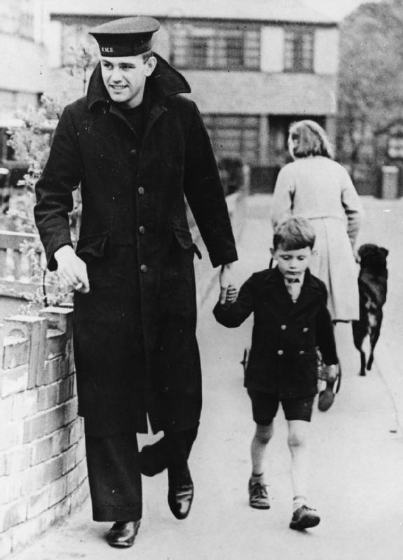 Able Seaman Robert Tilburn, one of the three survivors of HMS Hood, walking with his young brother in Leeds in June 1941, weeks after the sinking