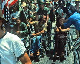 Ron Kovic and fellow Vietnam veteran protesters at the 1972 Republican National Convention in Miami, Florida, being filmed by a television camera crew